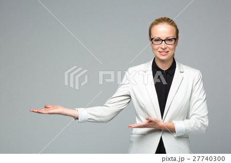 Business woman showing hand sign to side. Business woman showing hand sign to side. 27740300