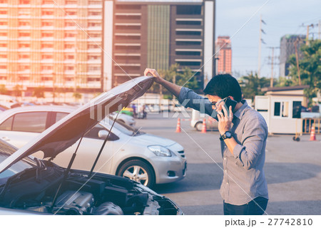 Young asian handsome man standing by the Broken Down car 27742810
