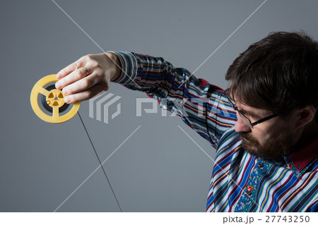 Bearded man looks at 8mm film 27743250