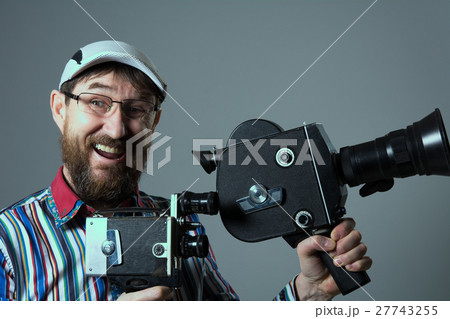 Laughing bearded man two old retro film camera 27743255