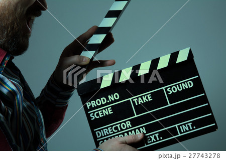 Man with clapperboard cinema 27743278