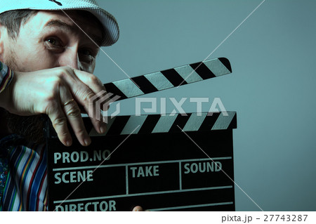 Close-up of a man smiling clapperboard cinema Close-up of a man smiling clapperboard cinema 27743287