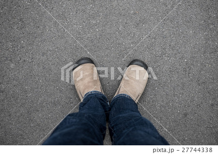 Man standing on concrete floor Man standing on concrete floor 27744338