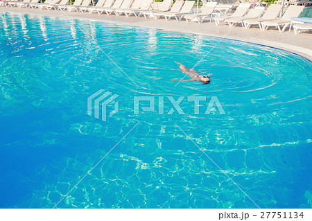 woman swimming on a blue water pool woman swimming on a blue water pool 27751134