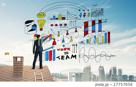 Rear view of businessman on house roof drawing his new business Rear view of businessman on house roof drawing his new business 27757656