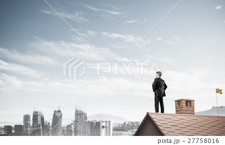 Mister boss on brick roof with arms akimbo. Mixed media Mister boss on brick roof with arms akimbo. Mixed media 27758016