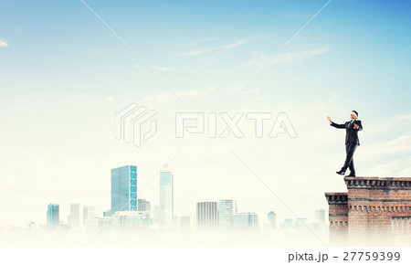 Danger and risk concept with businessman making step from edge 27759399