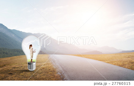 Businesswoman inside light bulb Businesswoman inside light bulb 27760315