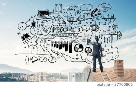 Rear view of businessman on house roof drawing his new business Rear view of businessman on house roof drawing his new business 27760806