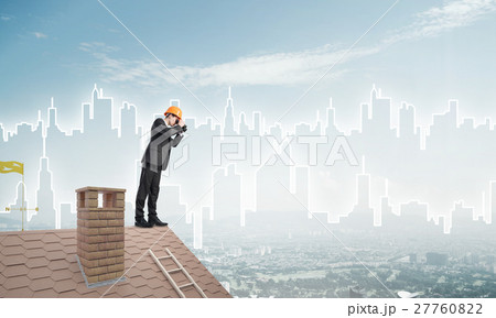 Engineer man standing on roof and looking in binoculars. Mixed media 27760822