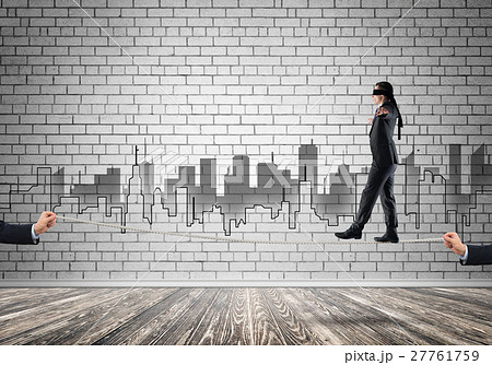 Business concept of risk support and assistance with man balancing on rope 27761759