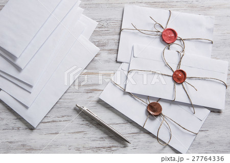 Letters with seal on table 27764336