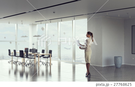 Businesswoman holding paper sheets mixed media Businesswoman holding paper sheets mixed media 27768625
