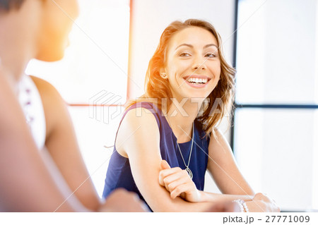 Young businesswoman sitting at desk and working 27771009