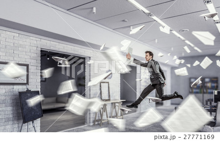 Jumping businessman in office 27771169
