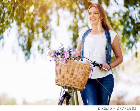 Happy young woman with bicycle Happy young woman with bicycle 27771883