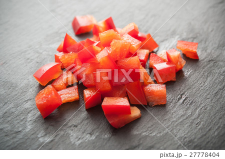 red peppers cubes on chalkboard background 27778404