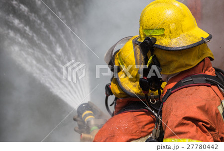two firemen in helmet and oxygen mask  27780442