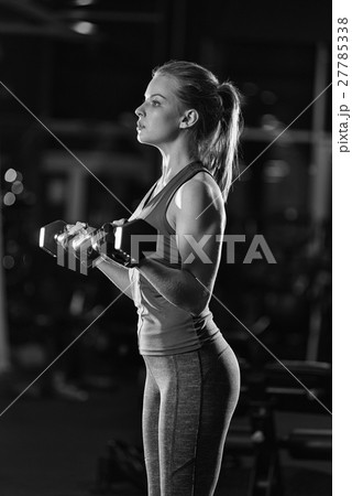 Young woman lifting the dumbbells Young woman lifting the dumbbells 27785338