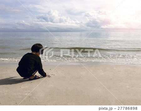 4 years old Asian boy sand writing  on beach  27786898