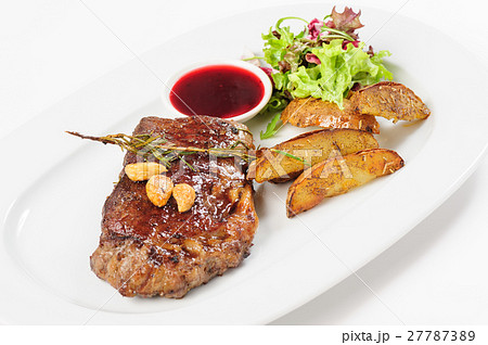 Thick juicy beef steak with potato and salad 27787389