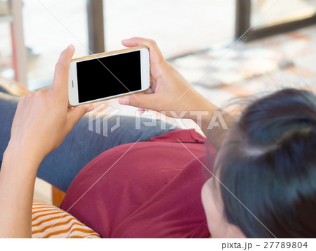 Pregnant Woman holding smart phone device.  27789804