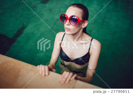 Beautiful brunette woman in funny sunglasses with 27790651