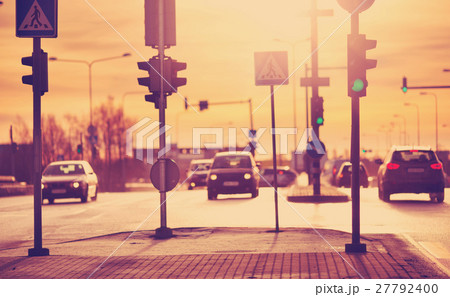 Cars moving on the road in city in early morning Cars moving on the road in city in early morning 27792400