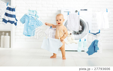 fun happy baby boy to wash clothes and laughs in laundry fun happy baby boy to wash clothes and laughs in laundry 27793606