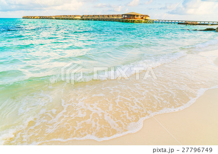 Beautiful water villas in tropical Maldives island at the sunrise time . 27796749