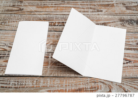 Bifold white template paper on wood texture . Bifold white template paper on wood texture . 27796787
