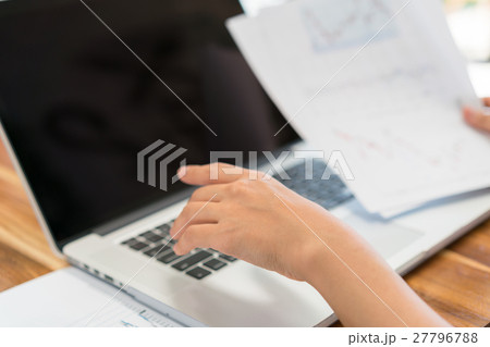 Business woman hand with Financial charts and laptop on the table . 27796788