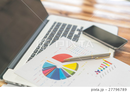Financial charts on the table with laptop . Financial charts on the table with laptop . 27796789