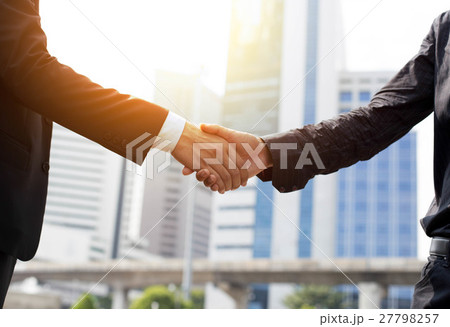 Business success hand shaking in front of building Business success hand shaking in front of building 27798257