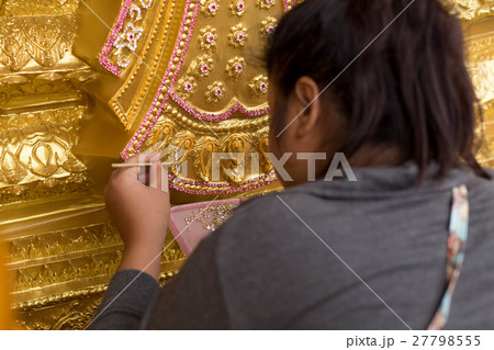 Woman handmade decorating base of Buddha statue 27798555