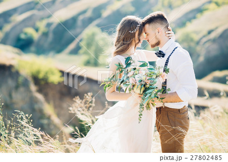 bride and groom hugging at the wedding in nature. bride and groom hugging at the wedding in nature. 27802485