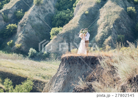 bride and groom hugging at the wedding in nature. bride and groom hugging at the wedding in nature. 27802545