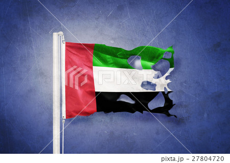 Torn flag of United Arab Emirates flying against 27804720