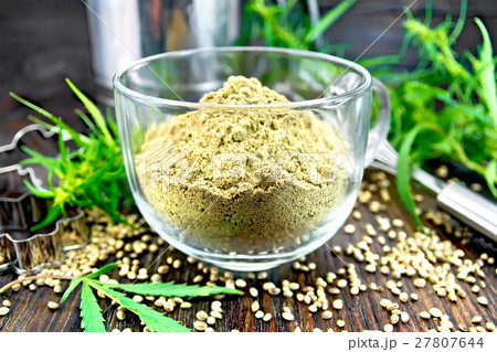 Flour hemp in glass cup on dark board 27807644