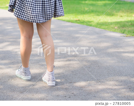Close up woman legs walk solely under tree shade Close up woman legs walk solely under tree shade 27810005