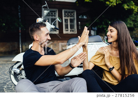 Cute couple with their scooter have fun 27815256