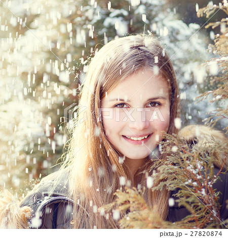 Young girl having fun in winter park 27820874