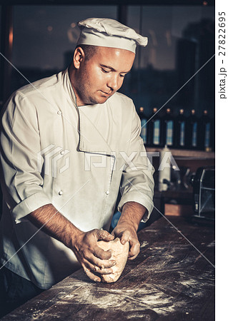 Busy chef at work in the restaurant kitchen Busy chef at work in the restaurant kitchen 27822695