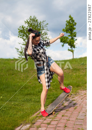 The woman does a trick with skate The woman does a trick with skate 27822987