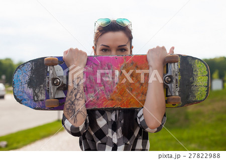 The woman holds a skate 27822988