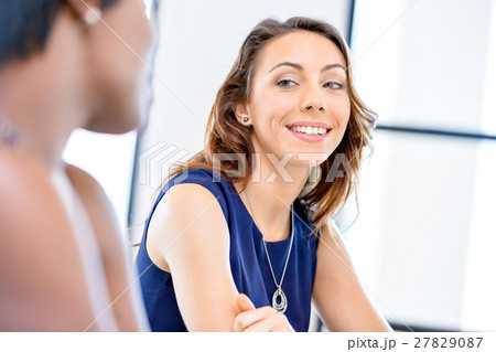 Young businesswoman sitting at desk and working 27829087