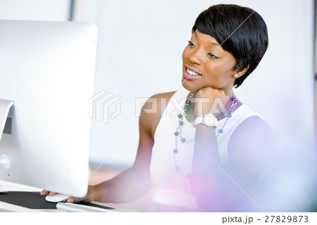 Portrait of businesswoman working at her desk in office 27829873