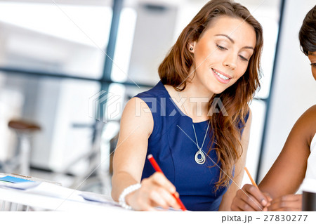 Women working together, office interior 27830277
