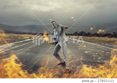 Businessman throwing petrol bomb 27831111