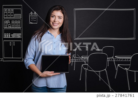 Cheerful professional teacher standing in the Cheerful professional teacher standing in the 27841761